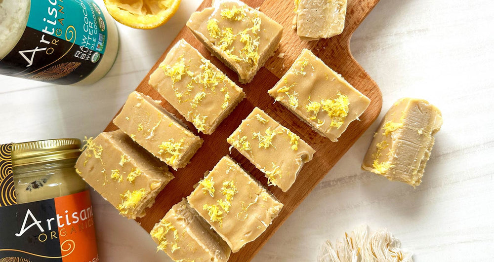 No-Bake Lemon Bars on a cutting board with jars of Coconut and Cashew Butters.