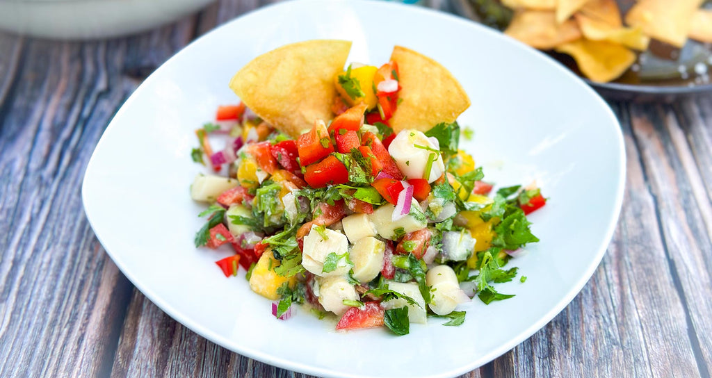 A plate with colorful coconut ceviche and tortilla chips