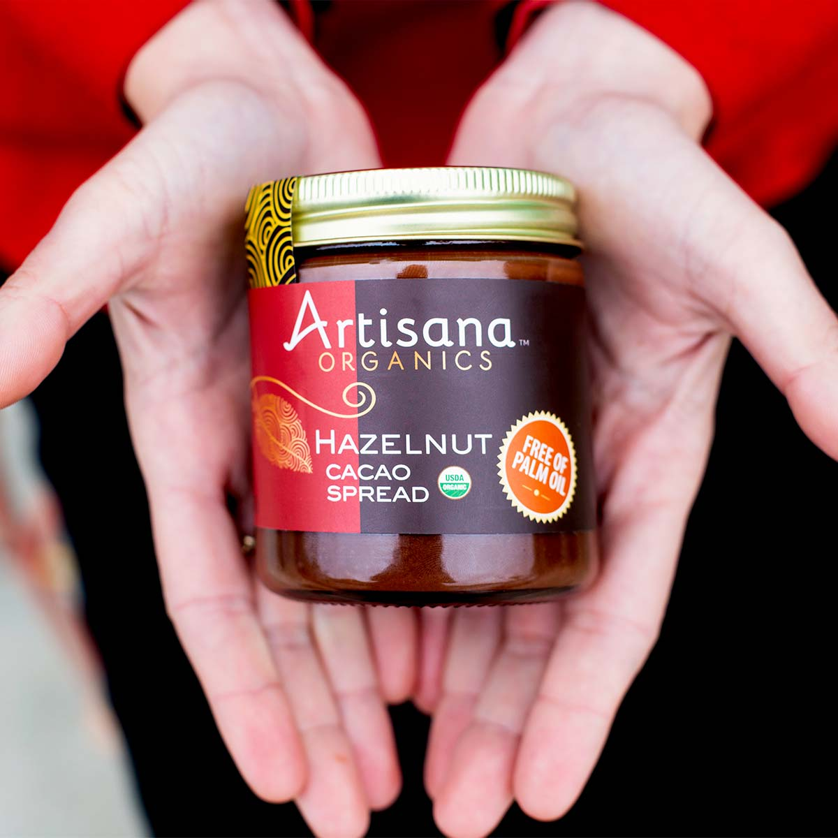 Jar of Hazelnut Cacao Spread held in a person's hands